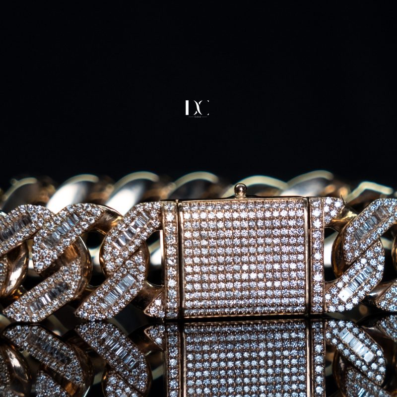 Close-up of Cuban link bracelet with custom iced out diamonds and baguette accents, crafted by hip hop jewellers | DC-JEWELLERS